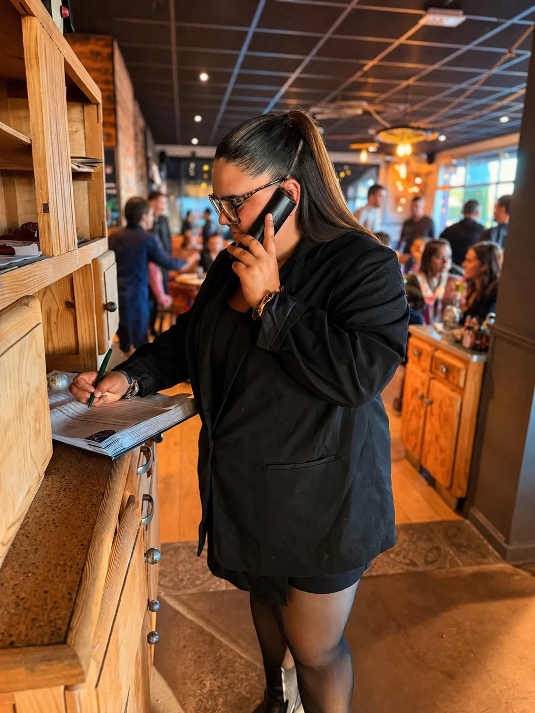 Restaurant manager taking reservation on phone