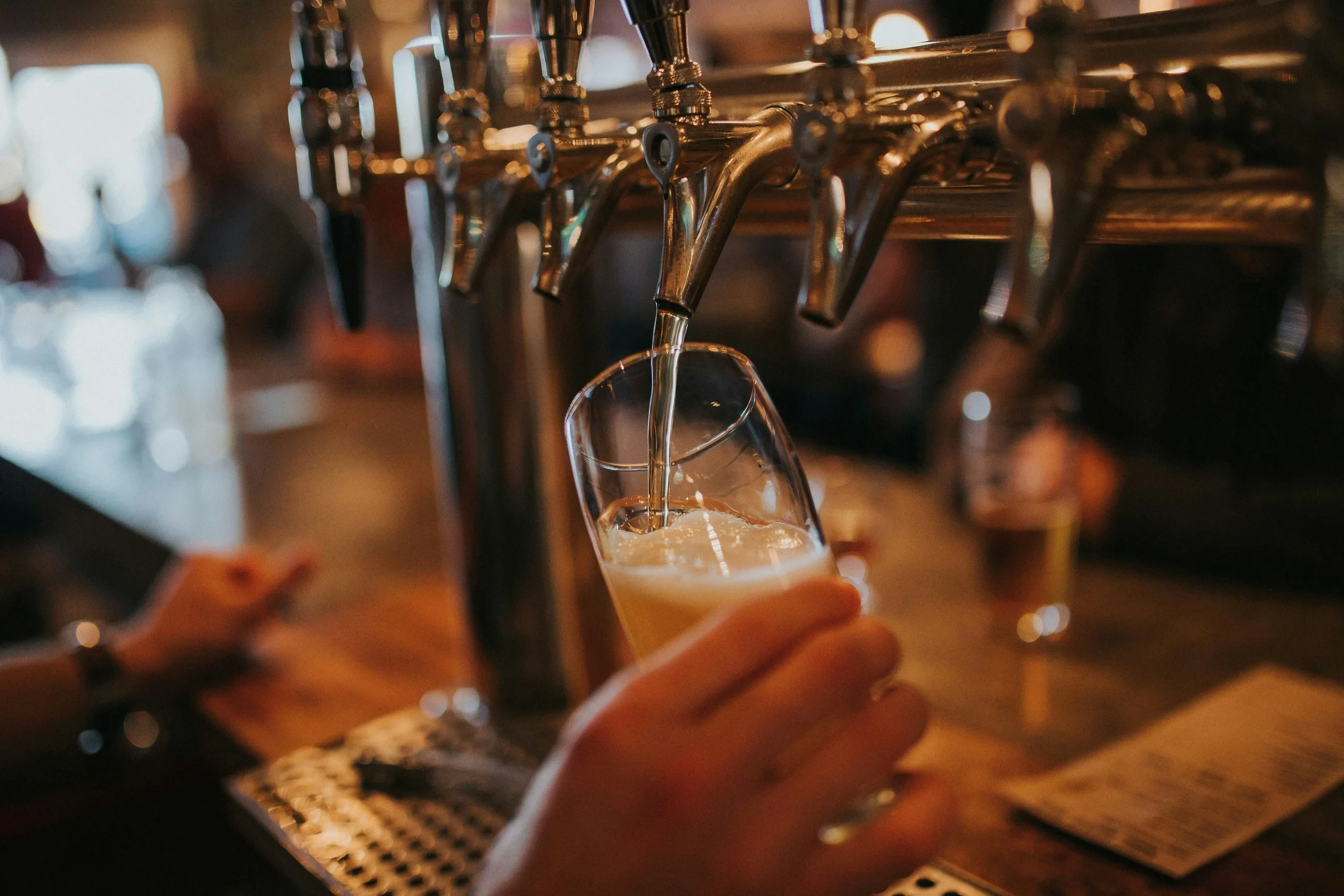 Beer pouring from tap into glass